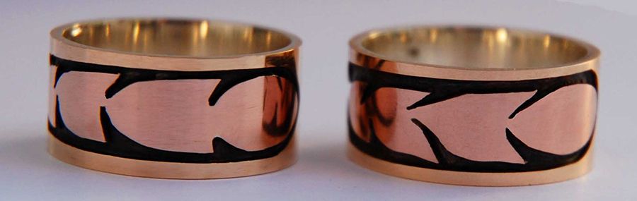 Set of wedding bands featuring stylized hawk feathers