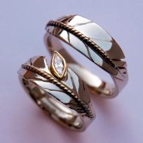 Oshkigin New Growth white gold eagle feather rings featuring a marquise-cut diamond
