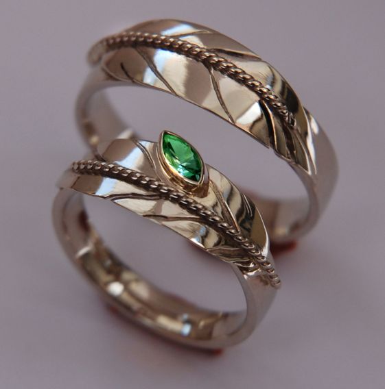 Ojibwe-style white gold Native American eagle feather wedding rings set with emerald 