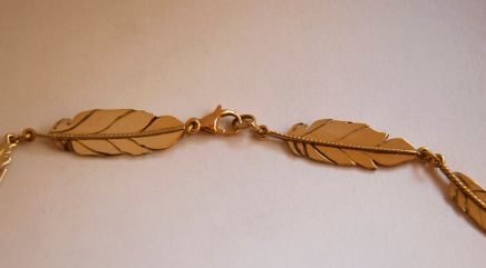Gold eagle feather fastening of the necklace Spirit of the Three Fires