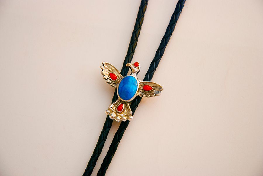 Image of the bolo tie titled Giizisogekek (Sun Hawk) handcrafted by Woodland artist jeweler Zhaawano