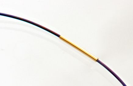 Detail of gold tube fastening