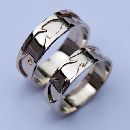 Native American Ojibwe overlay feather rings of white gold titled Izhinaamowin