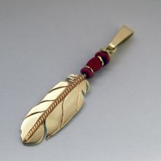 Native American eagle feather pendant of gold and red coral