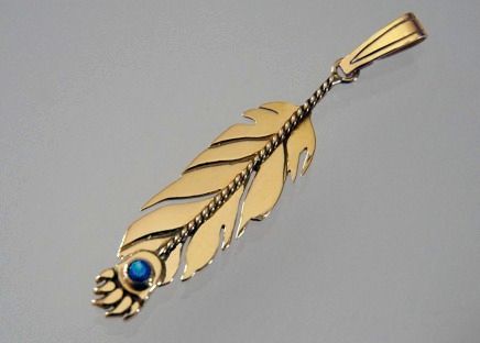 Gold eagle feather pendant with bear claw tip set with turquoise